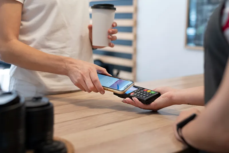 person paying with its smartphone wallet app