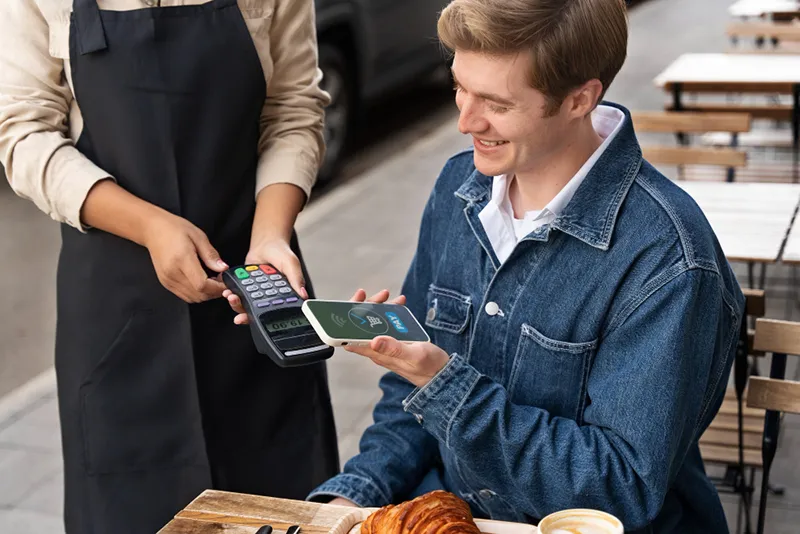 side view customer paying with nfc device