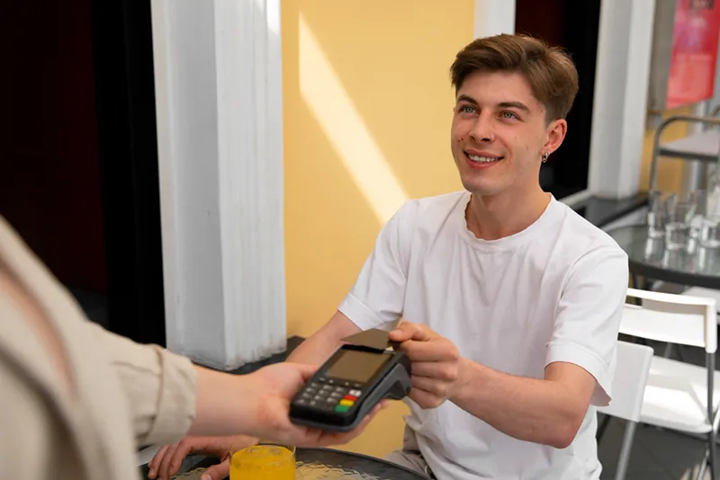 side view customer paying with nfc device
